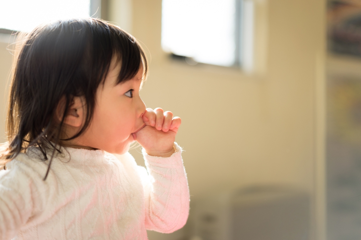 Toddler sucking thumb, a common dental habit in kids that can affect dental development