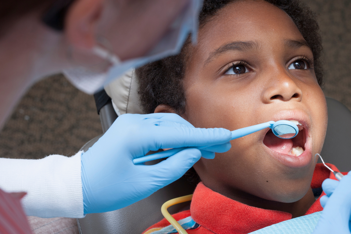Child during a first orthodontic visit receiving an early orthodontic evaluation to assess bite development and determine if age 7 orthodontist care is recommended.